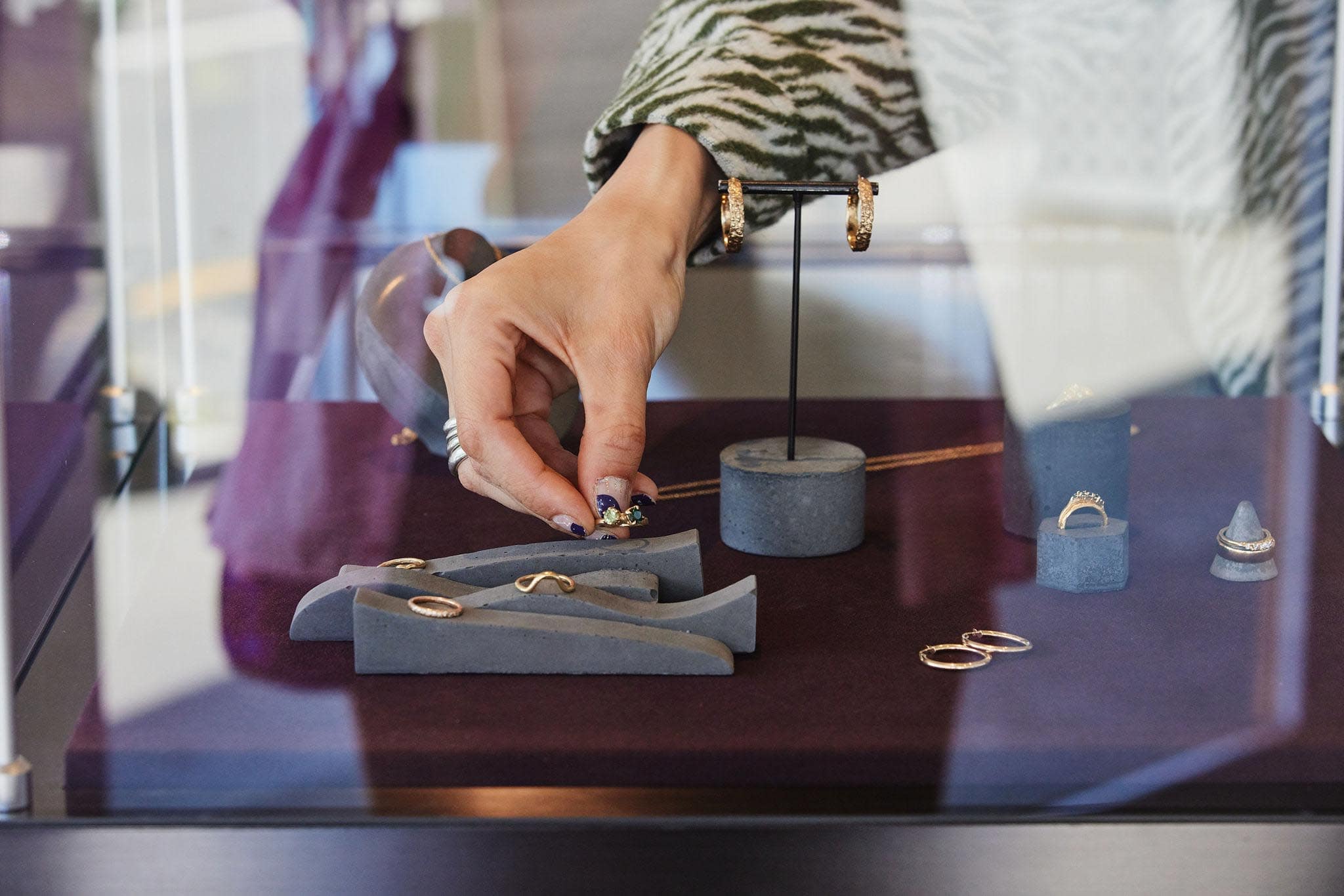 Hand selecting a piece of Black Finch jewellery