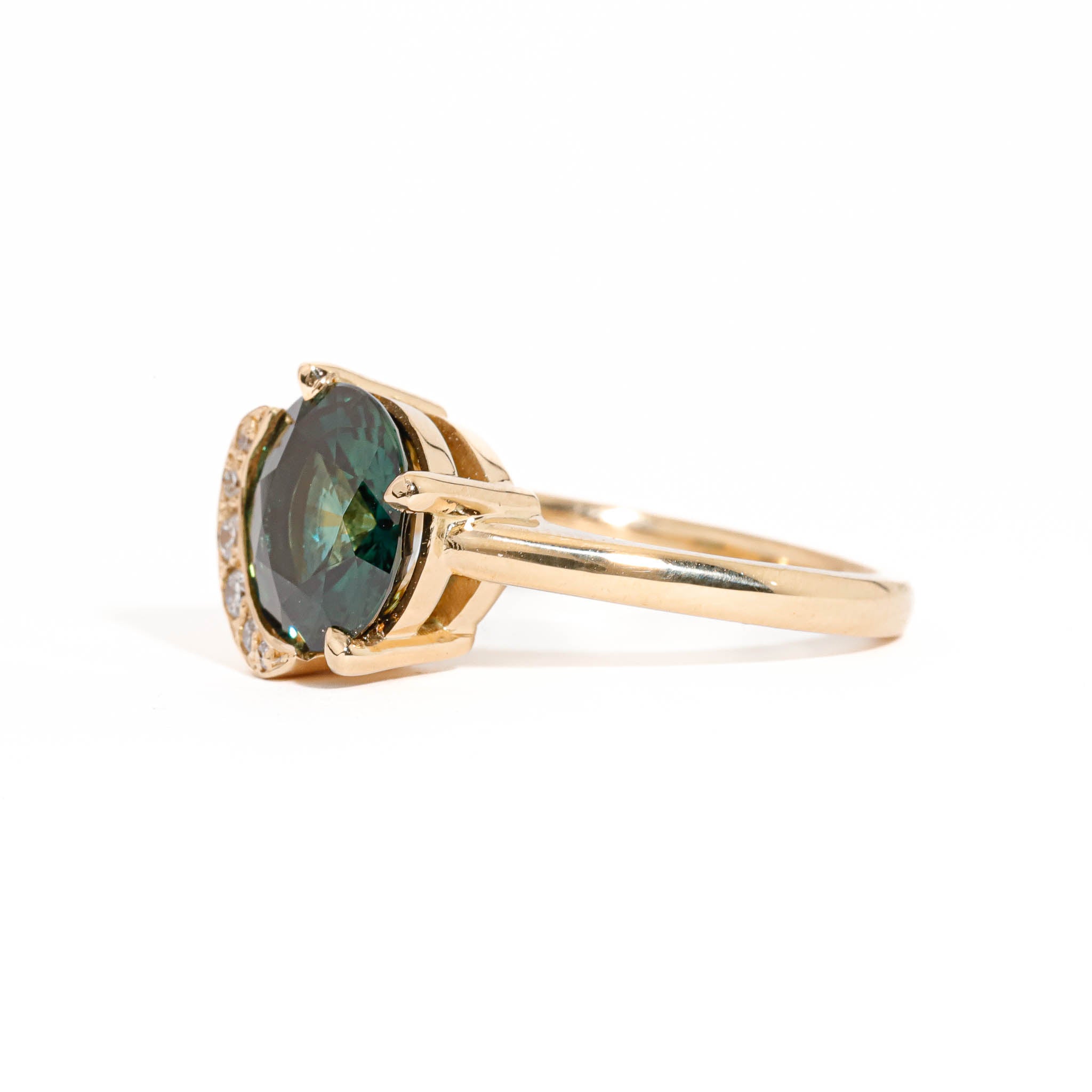 Round Brilliant Cut Teal Sapphire with Half Halo of White Diamonds in 18 carat Yellow Gold
