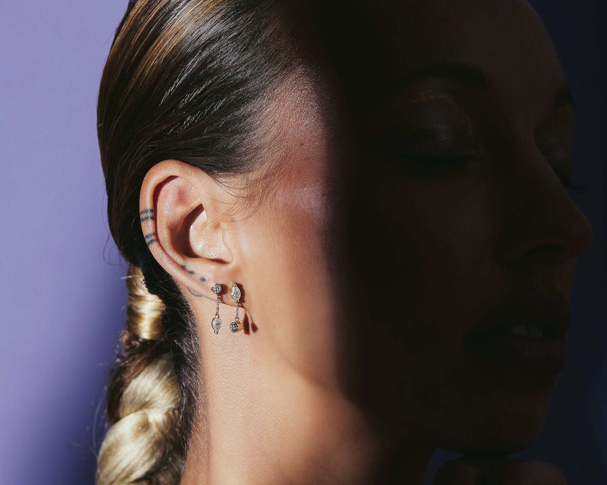 drop diamond earrings on model