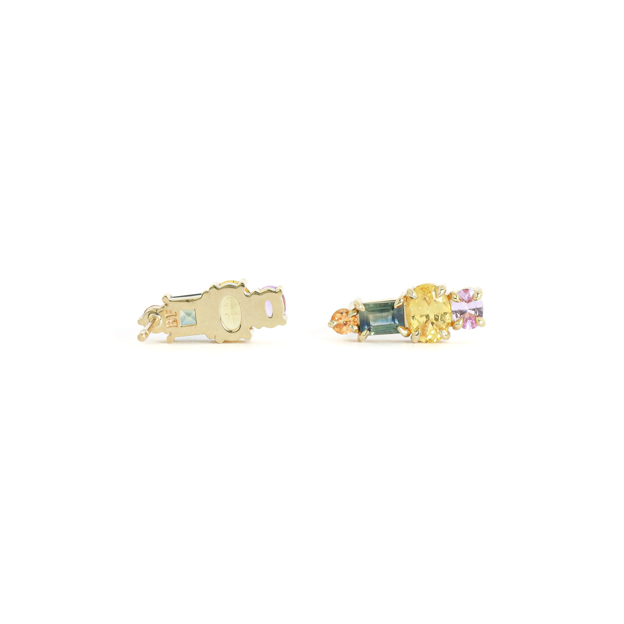 Gold earrings with gemstones on a white background