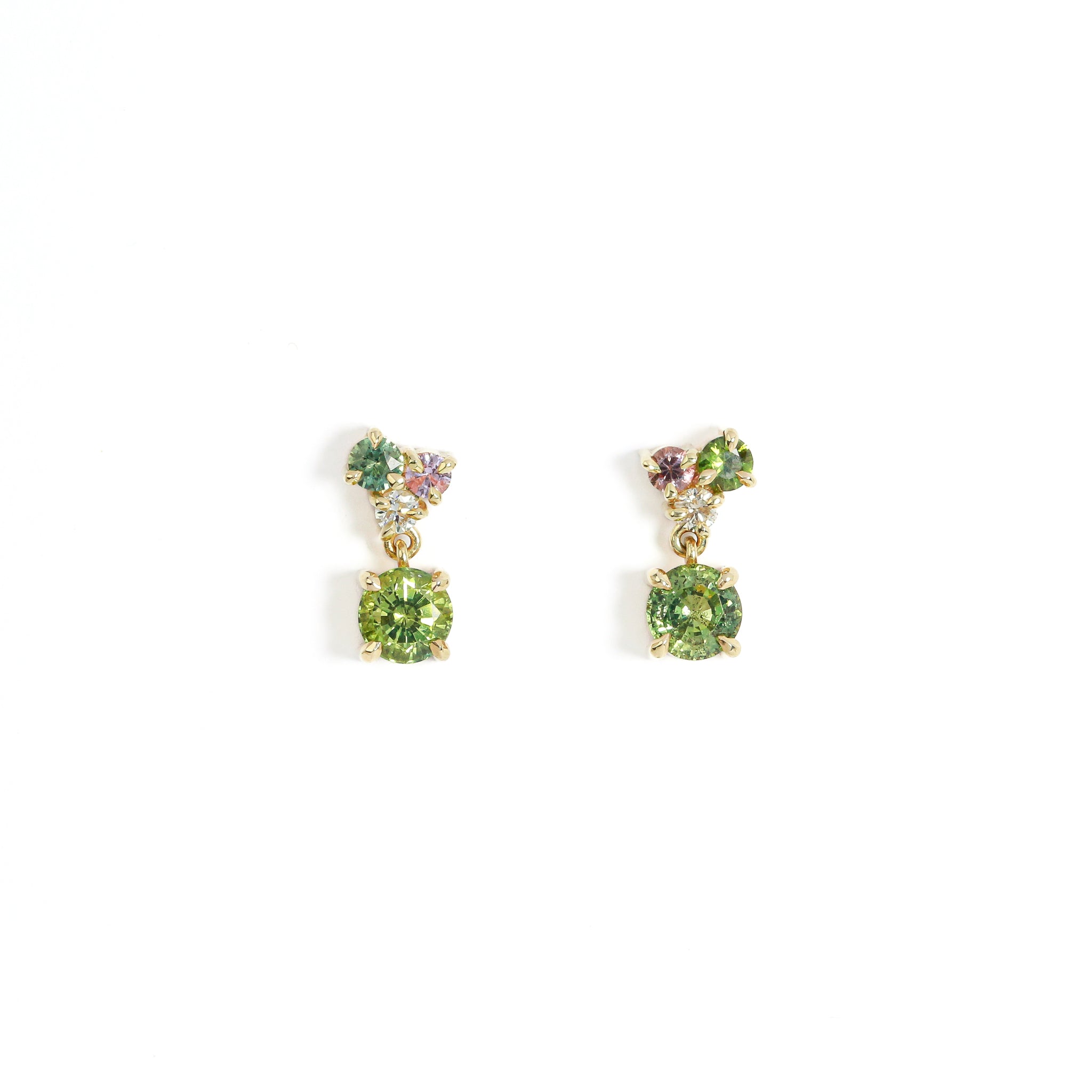 Pair of earrings with green gemstones on a white background