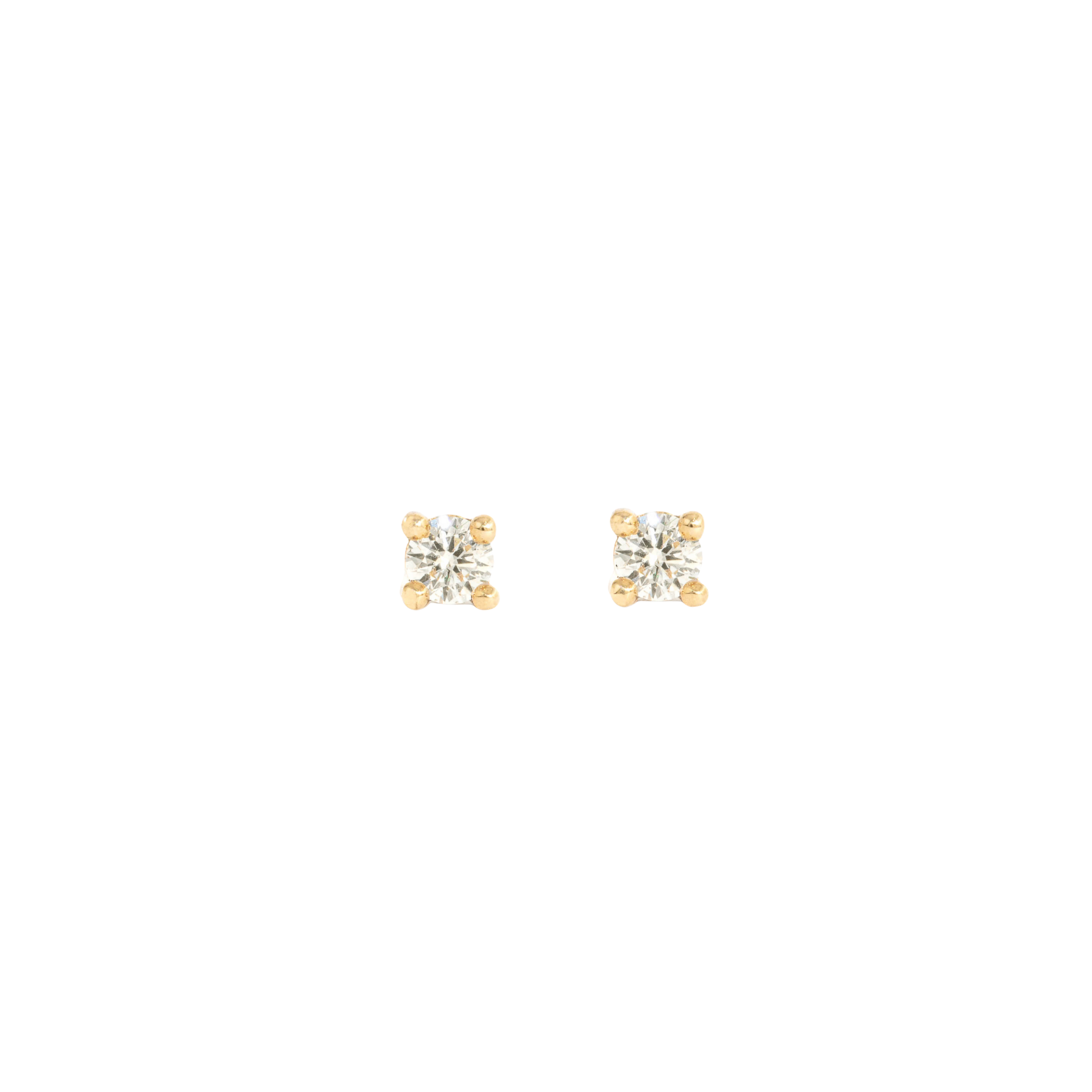 pair of white diamond stud earrings in yellow gold