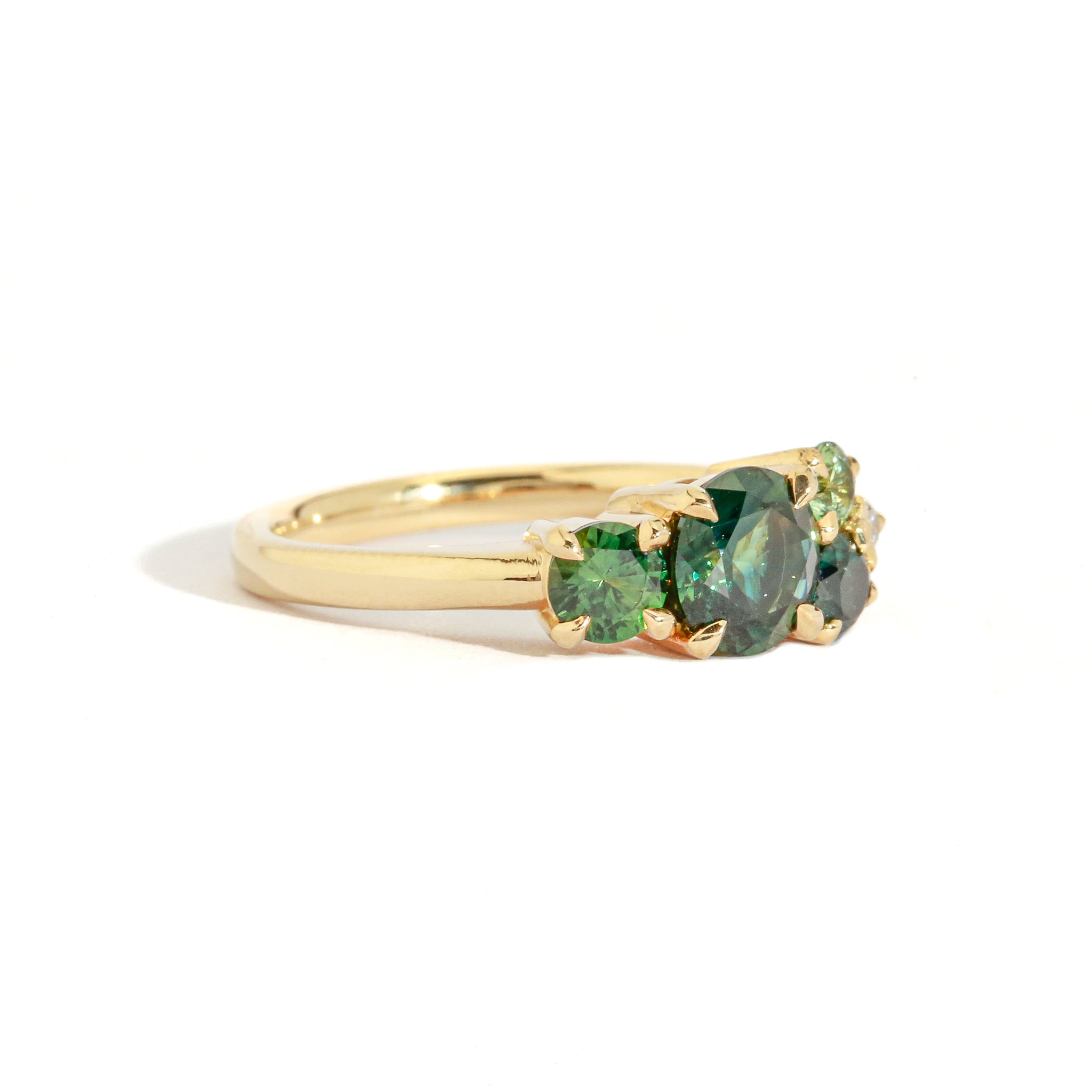 gold cluster ring with green gemstones