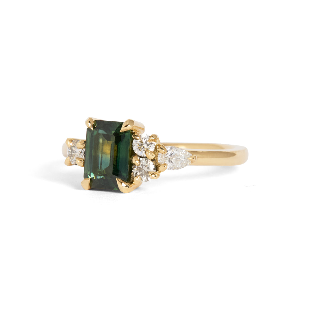 Yellow gold ring featuring a rectangular green centre gemstone in a four-prong setting, accented by clusters of round and pear-shaped white gemstones on either side.