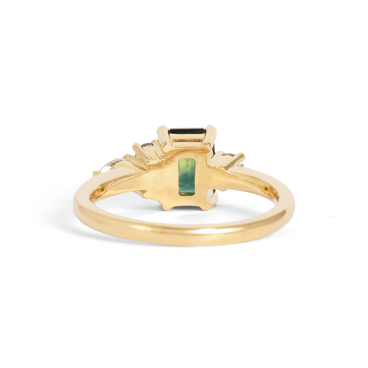 Yellow gold ring featuring a rectangular green centre gemstone in a four-prong setting, accented by clusters of round and pear-shaped white gemstones on either side.