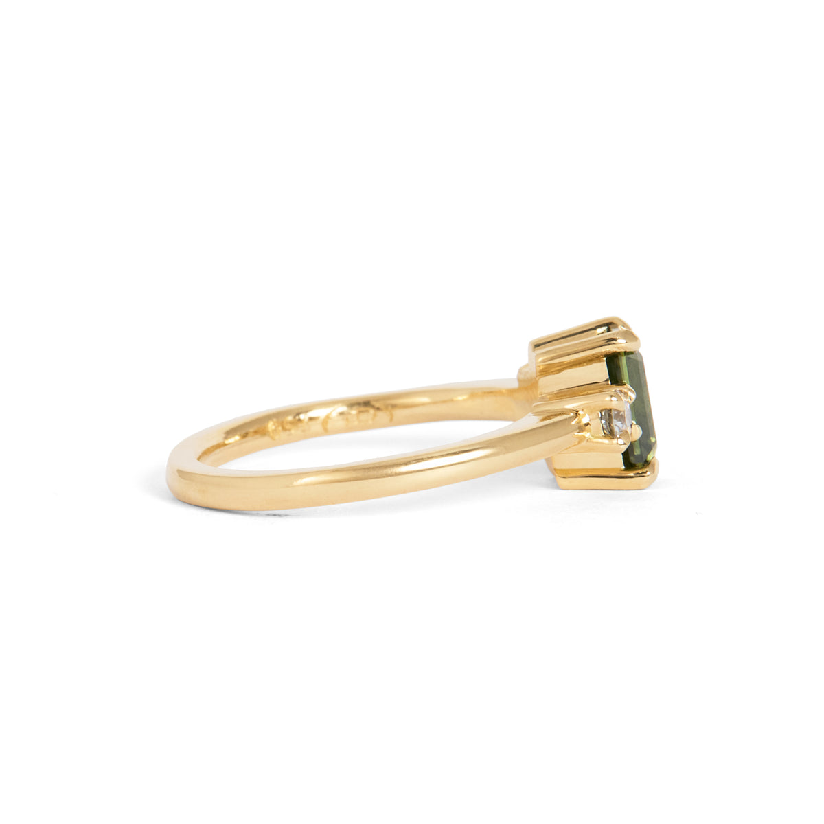 Yellow gold ring featuring a rectangular green centre gemstone in a four-prong setting, accented by clusters of round and pear-shaped white gemstones on either side.