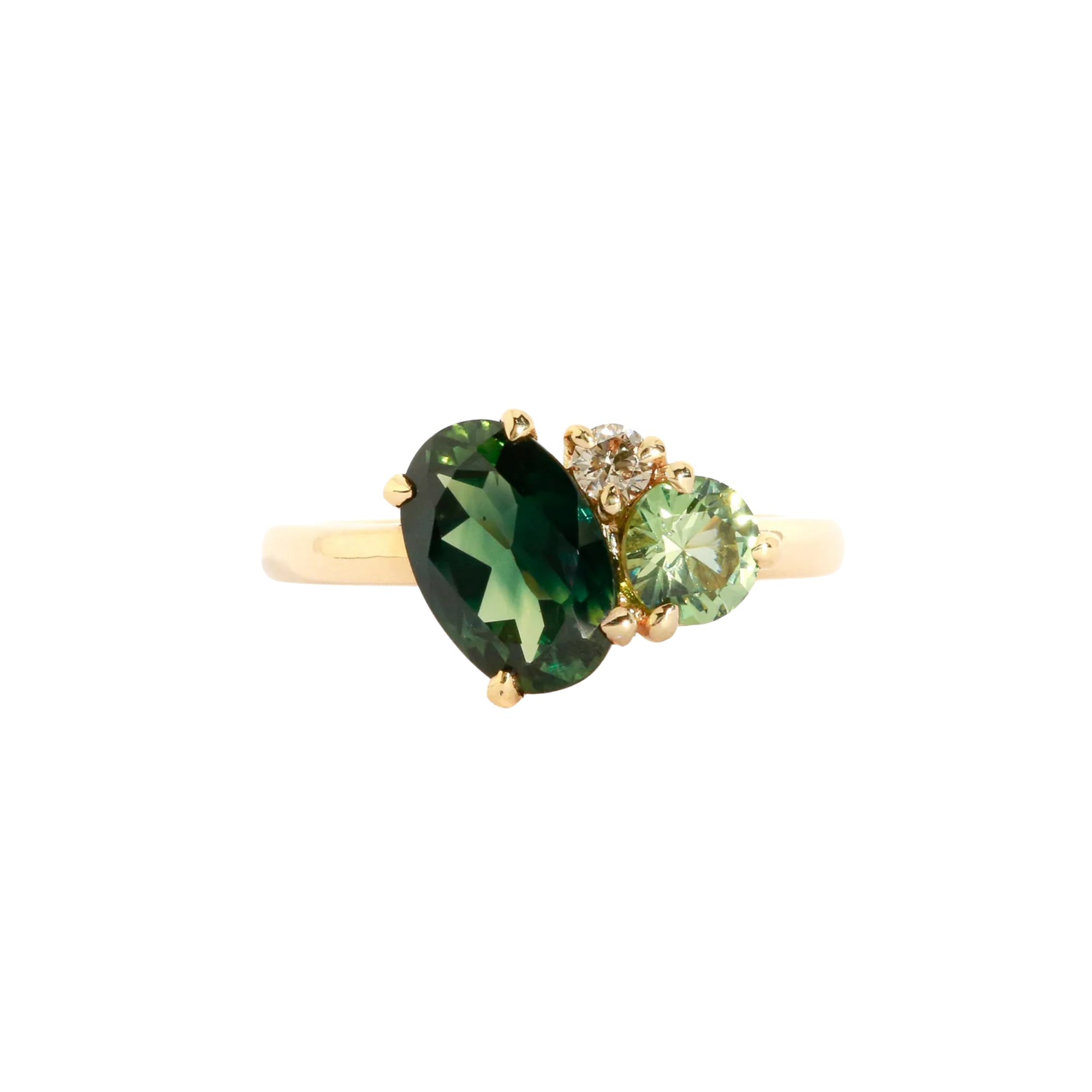 Asymmetrical gold three stone ring with a central oval cut green sapphire.