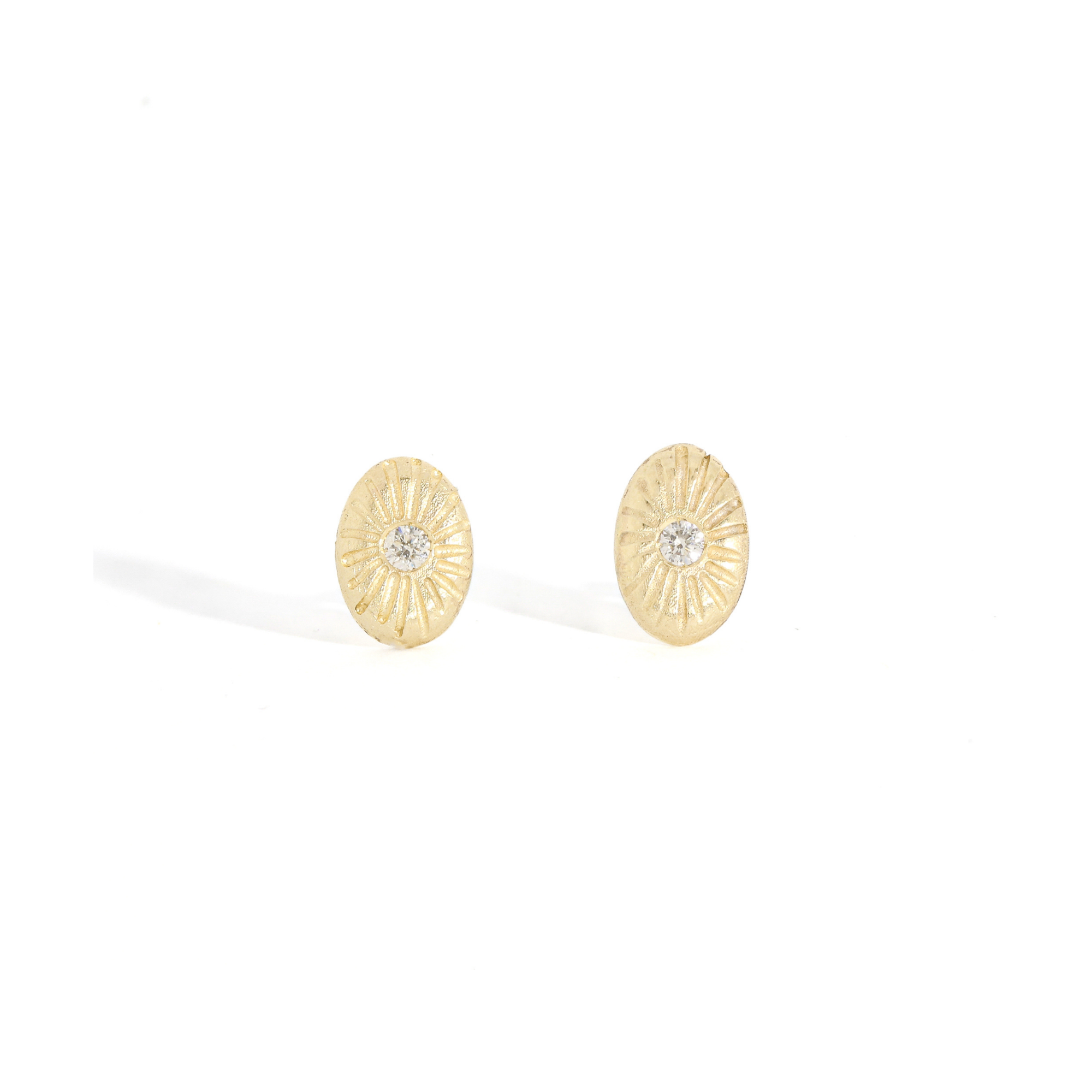 pair of gold oval studs with engraving detail