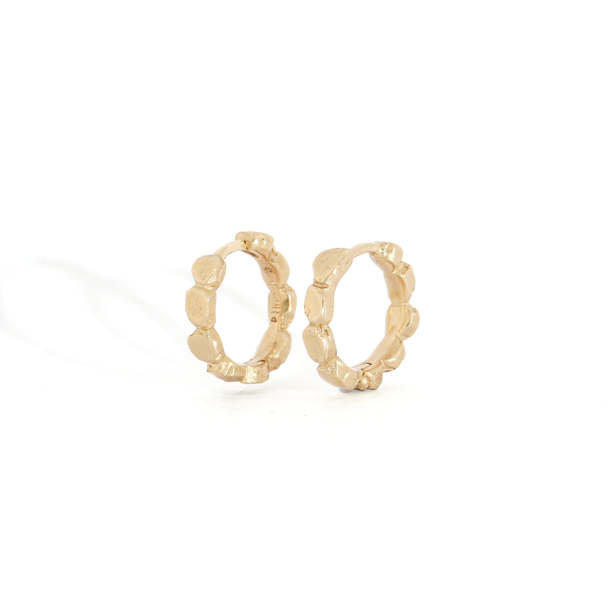 Gold hoop earrings on a white background