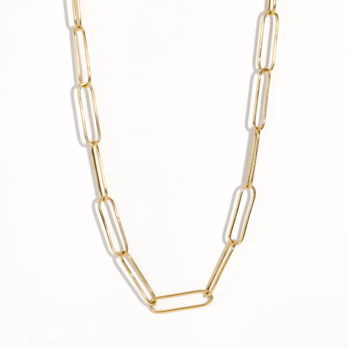 Gold paperclip chain by Black Finch Jewellery. Long thin gold links connected on as a chain.