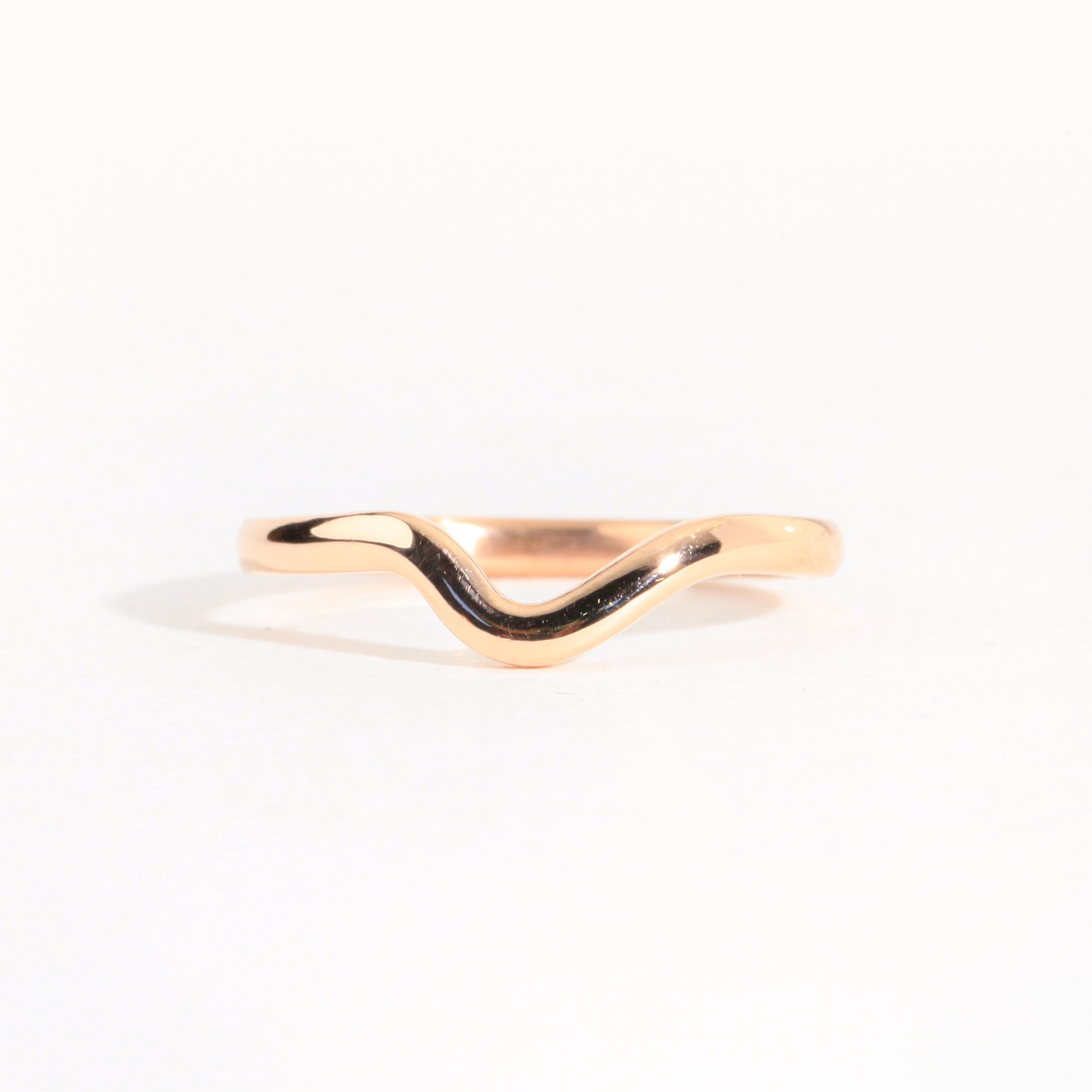 Handmade 18 carat rose gold dimpled band with a polished finish.
