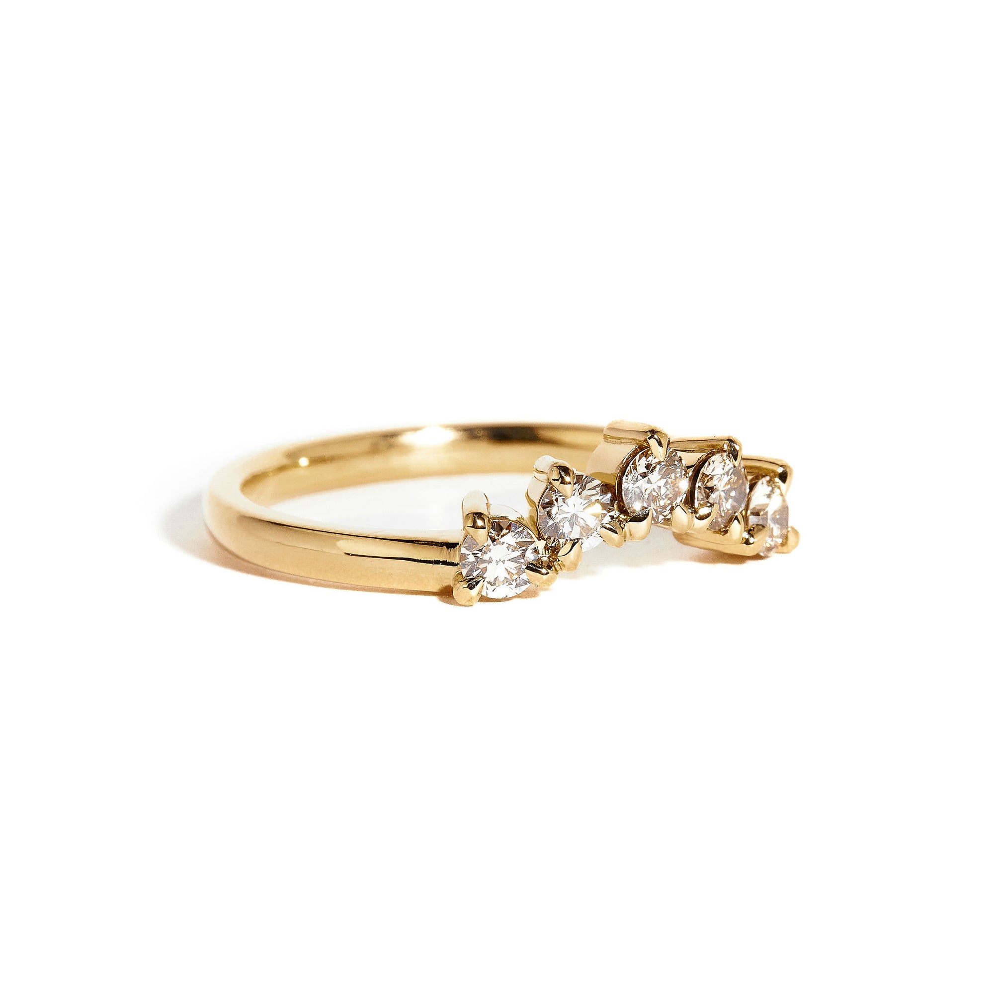 18 carat yellow gold woman's wedding band with 5 round champagne diamonds, claw set in a slight curve.