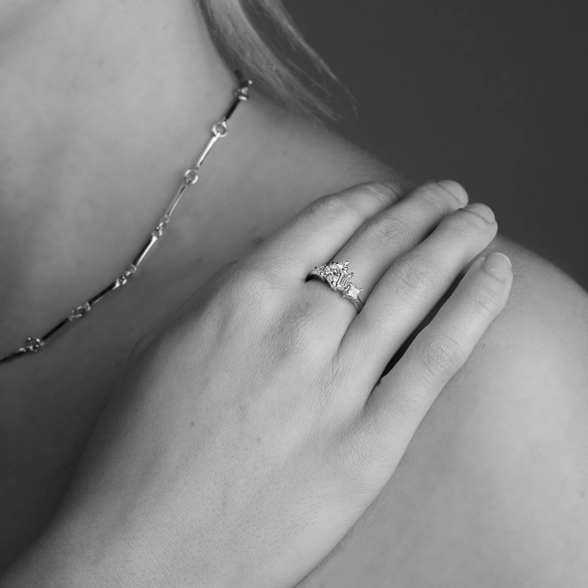 Five Stone Pear Cut, Baguette Cut and Princess Cut White Diamond Engagement Ring in 18 carat Yellow Gold worn on the hand