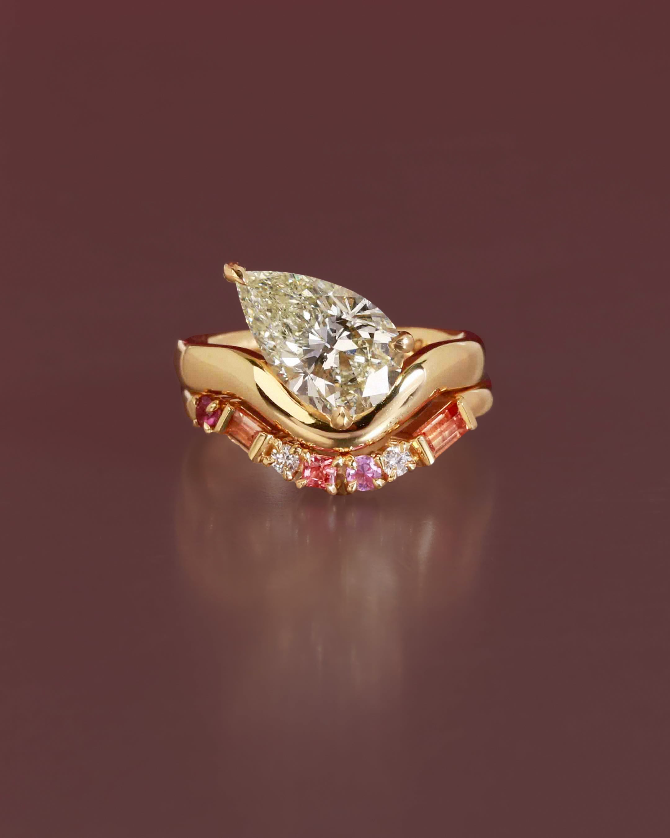 pear diamond engagement ring and pink sapphire curved wedding band