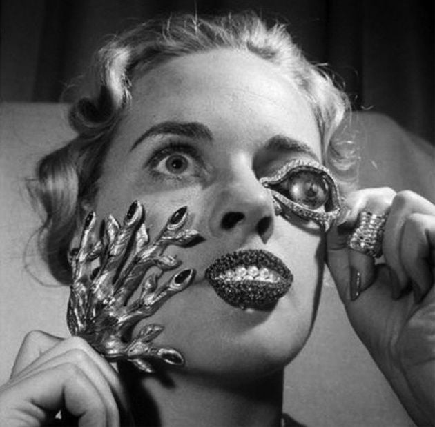 Black and white photograph featuring Dali inspired jewels on a woman's face