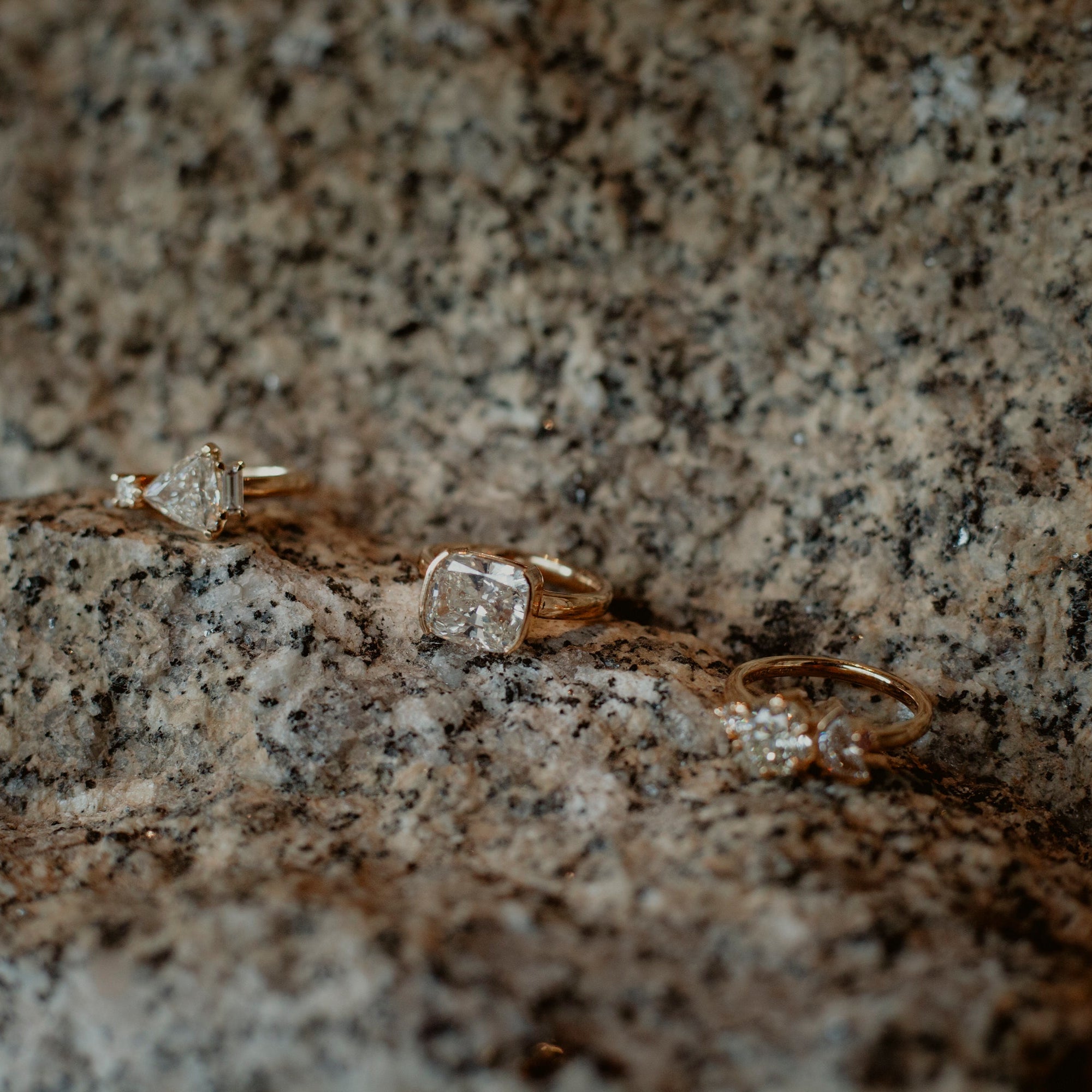 diamond rings placed on natural stone