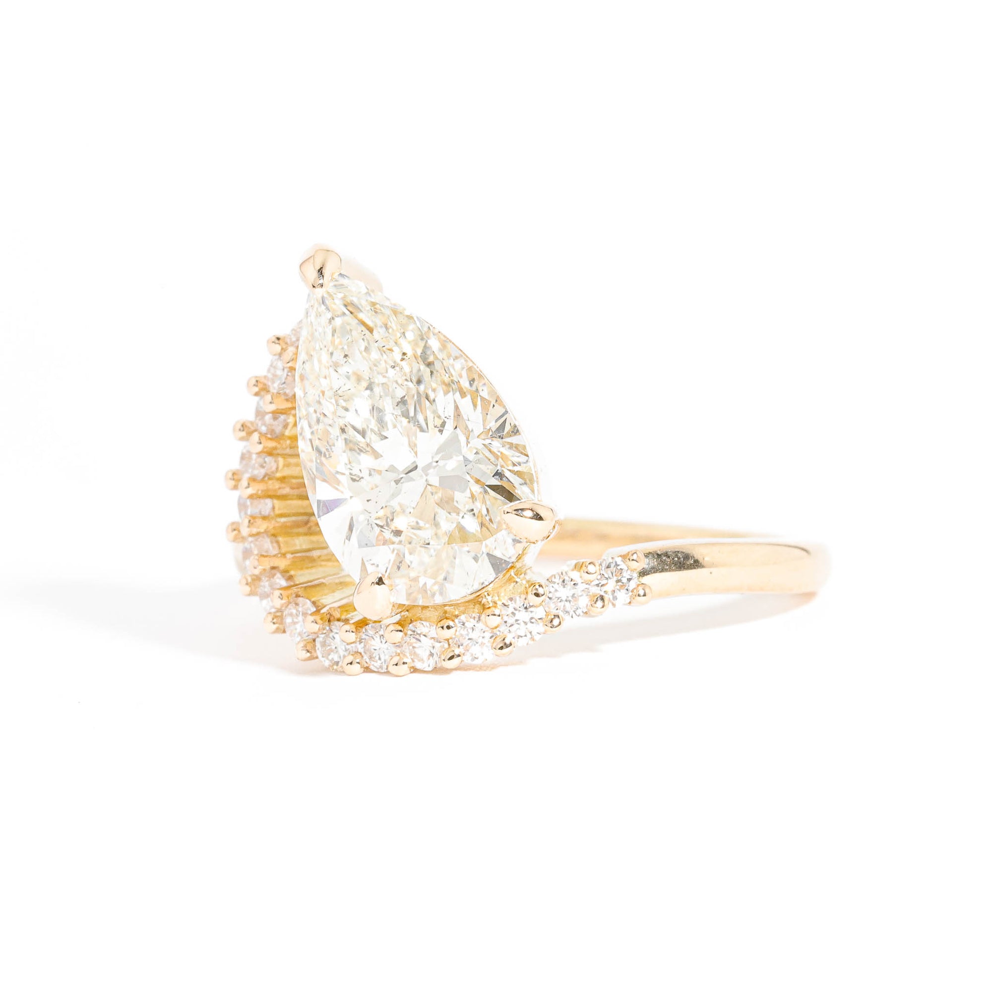 Pear Cut Diamond with an Arch of Thirteen Round Brilliant Cut Diamonds in 18 Carat Yellow Gold