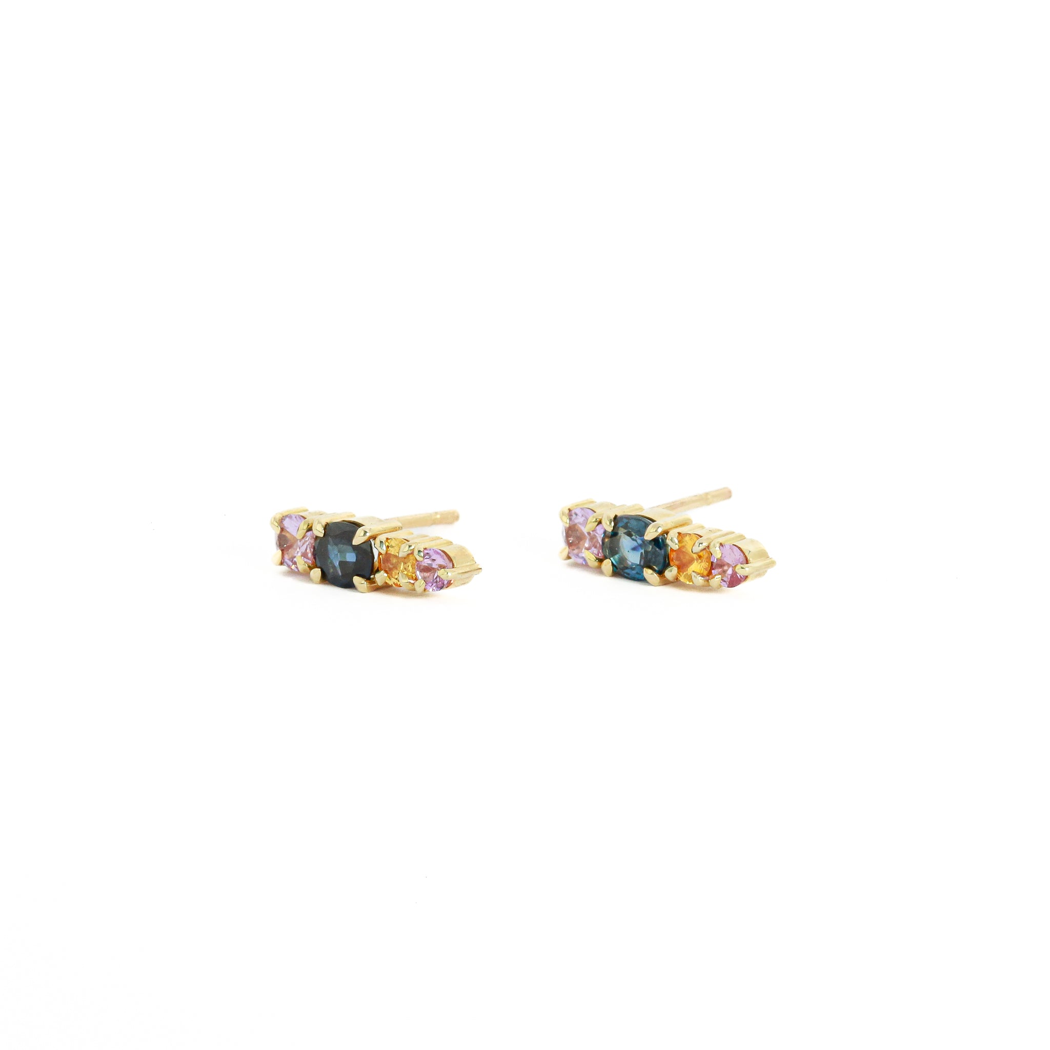 Pair of gold earrings with gemstones on a white background
