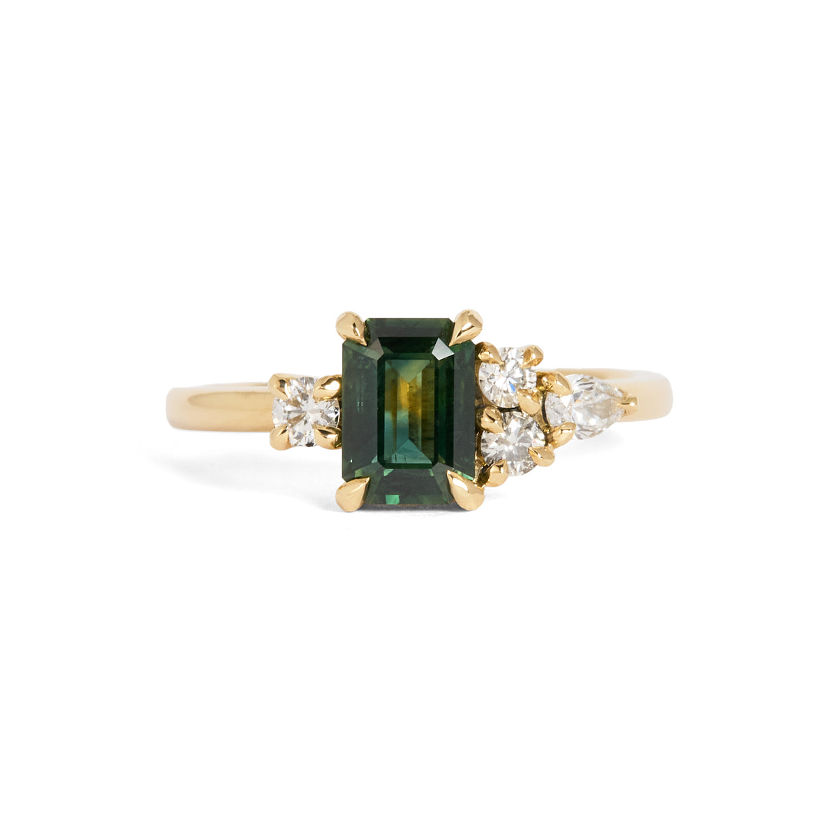 Yellow gold ring featuring a rectangular green centre gemstone in a four-prong setting, accented by clusters of round and pear-shaped white gemstones on either side.