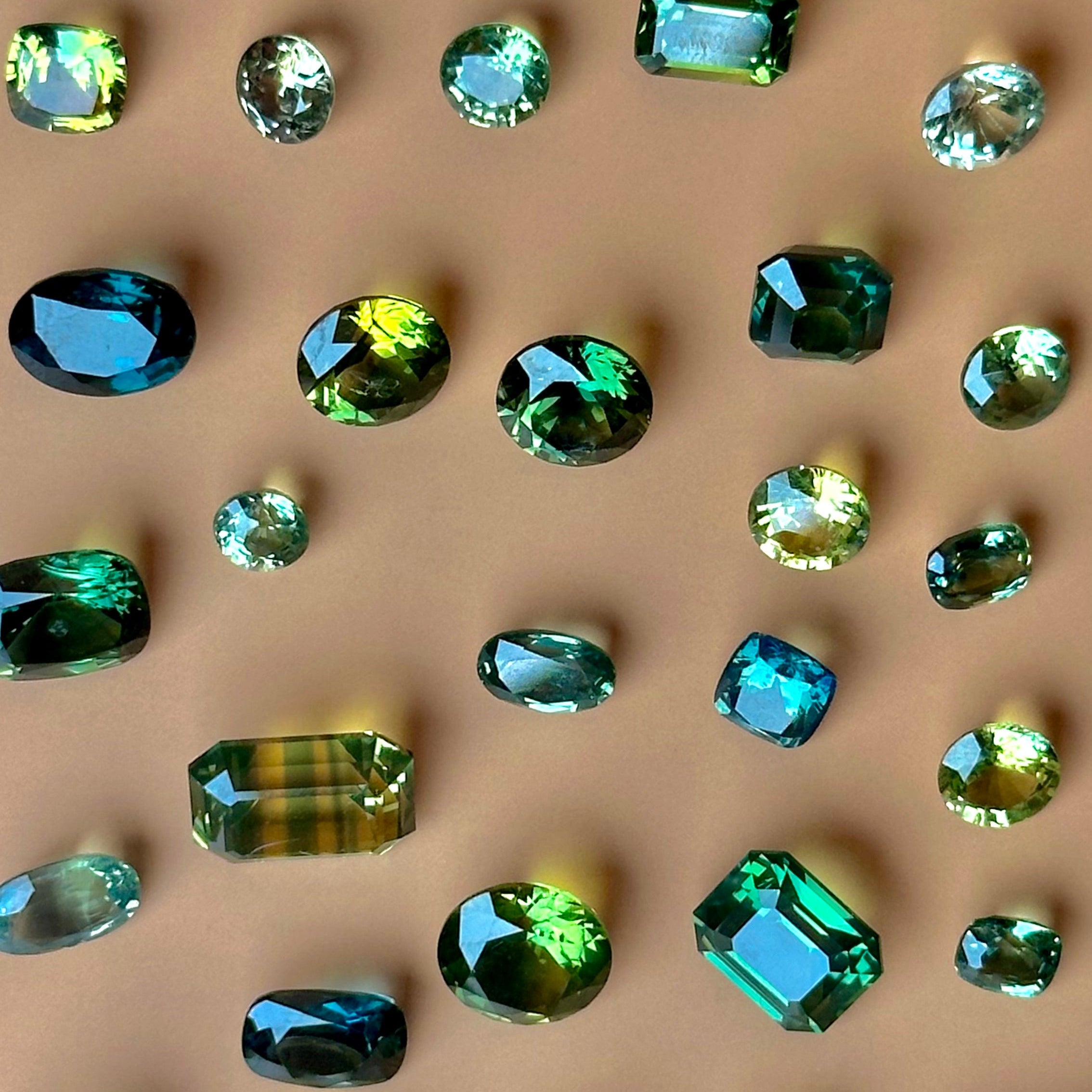 a mix of loose green sapphires