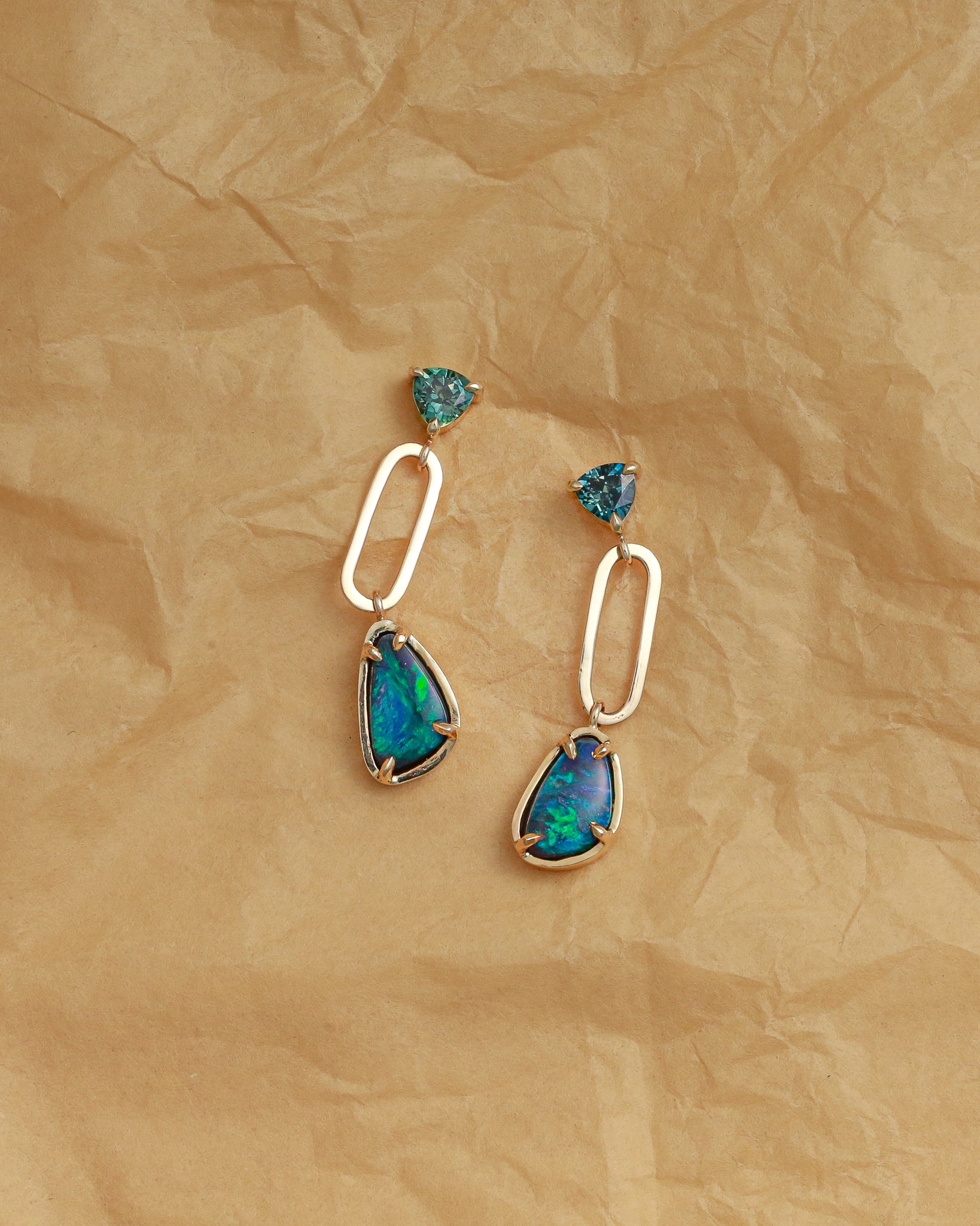 opal drop earrings on paper background