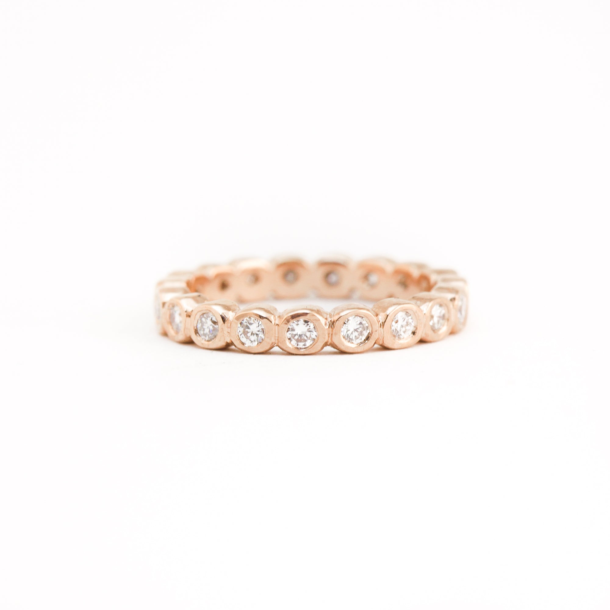 Bespoke 18 carat rose gold eternity ring, set with 23 round brilliant cut white diamonds.