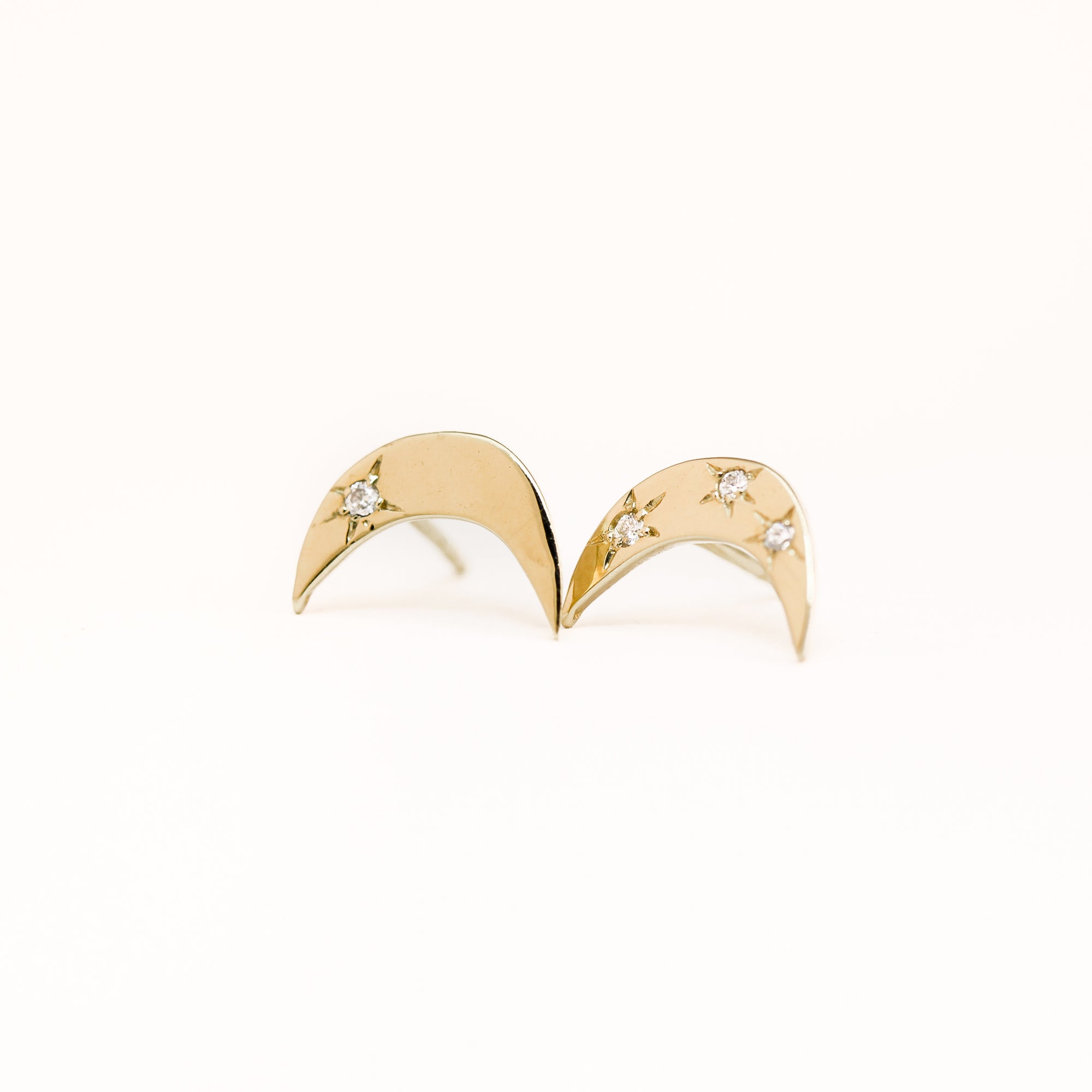 Handmade 9 carat yellow gold moon shaped studs, set with four round diamonds. 
