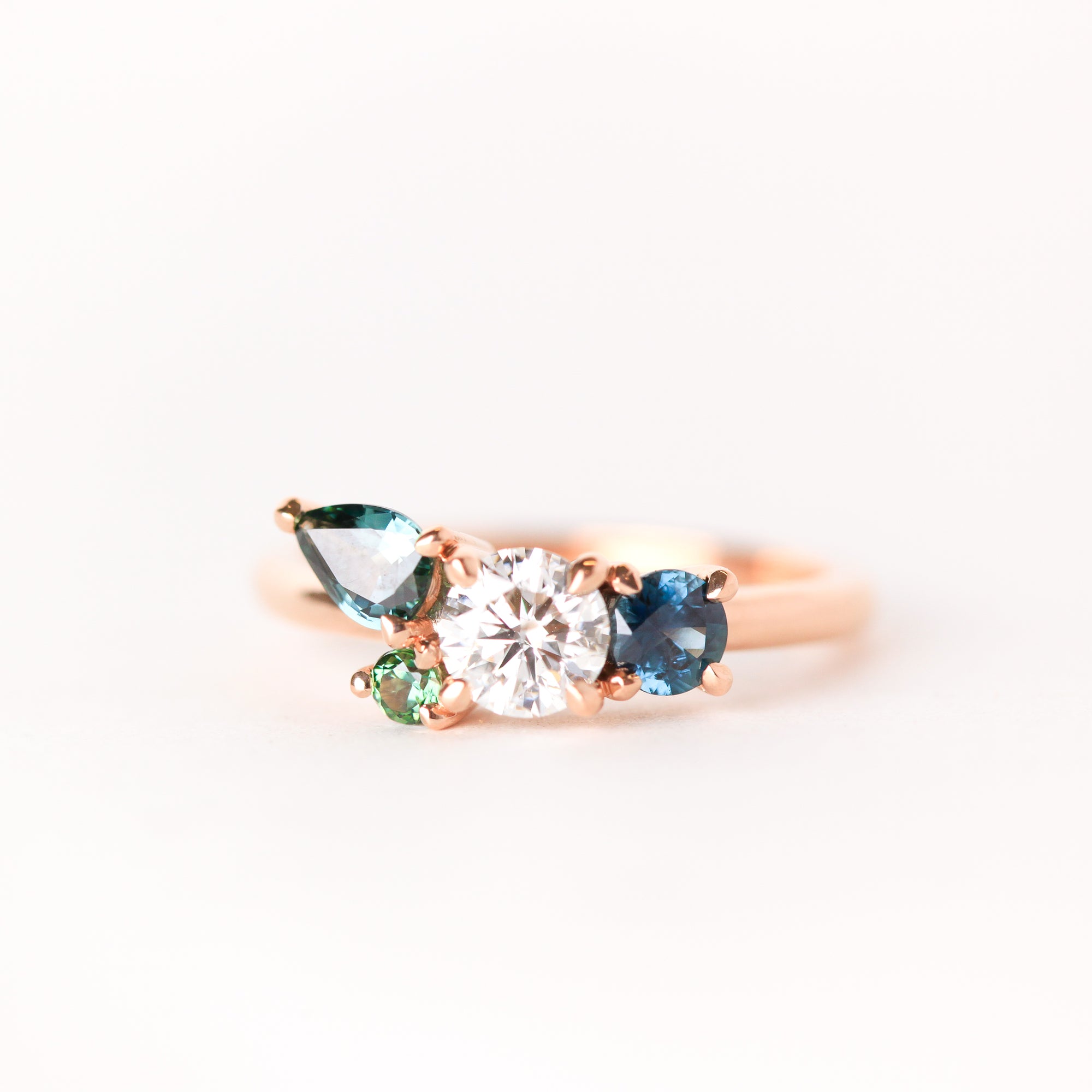 Cluster ring with central diamond, surrounded by sapphires in both round and pear shapes. Made in Melbourne. 
