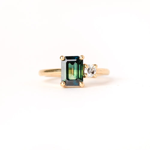 Ethically sourced emerald cut sapphire along side a white diamond. Crafted with recycled, refined gold. Made in Melbourne. 