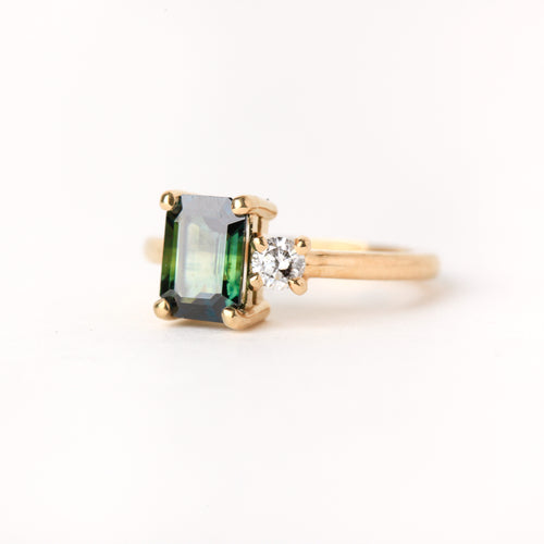 Ethically sourced emerald cut sapphire along side a white diamond. Crafted with recycled, refined gold. Made in Melbourne. 