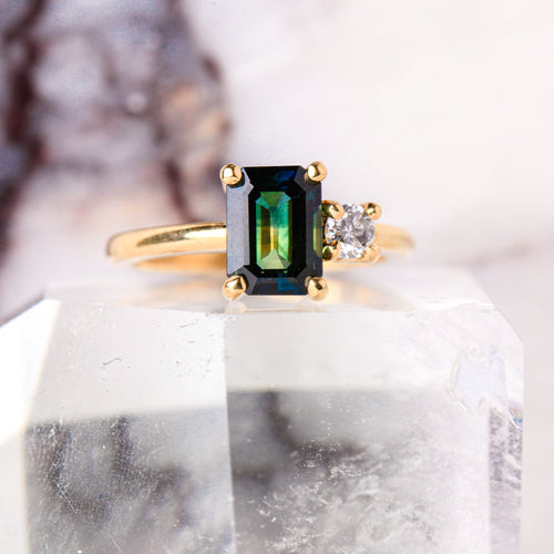 Ethically sourced emerald cut sapphire along side a white diamond. Crafted with recycled, refined gold. Made in Melbourne. 