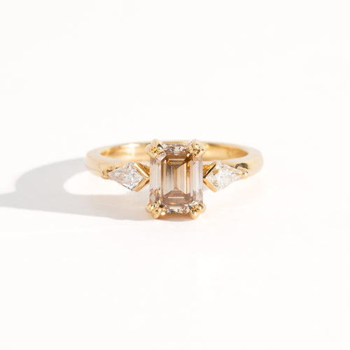 Bespoke engagement ring with rectangular radiant cut champagne diamond surrounded by kite cut white diamonds. Recycled, refined gold custom and crafted in Melbourne by black Finch Jewellery