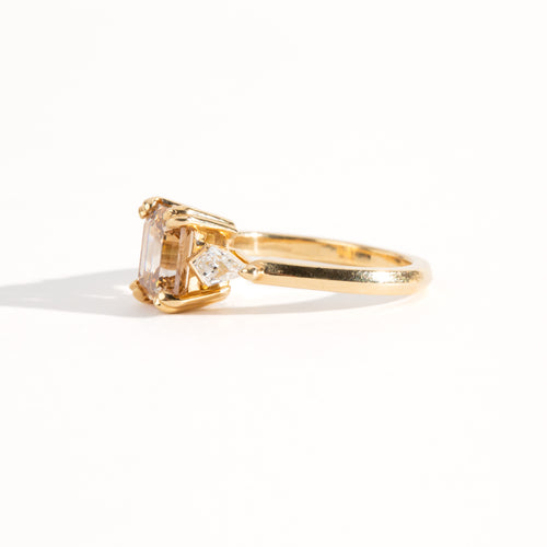 Bespoke engagement ring with rectangular radiant cut champagne diamond surrounded by kite cut white diamonds. Recycled, refined gold custom and crafted in Melbourne by black Finch Jewellery