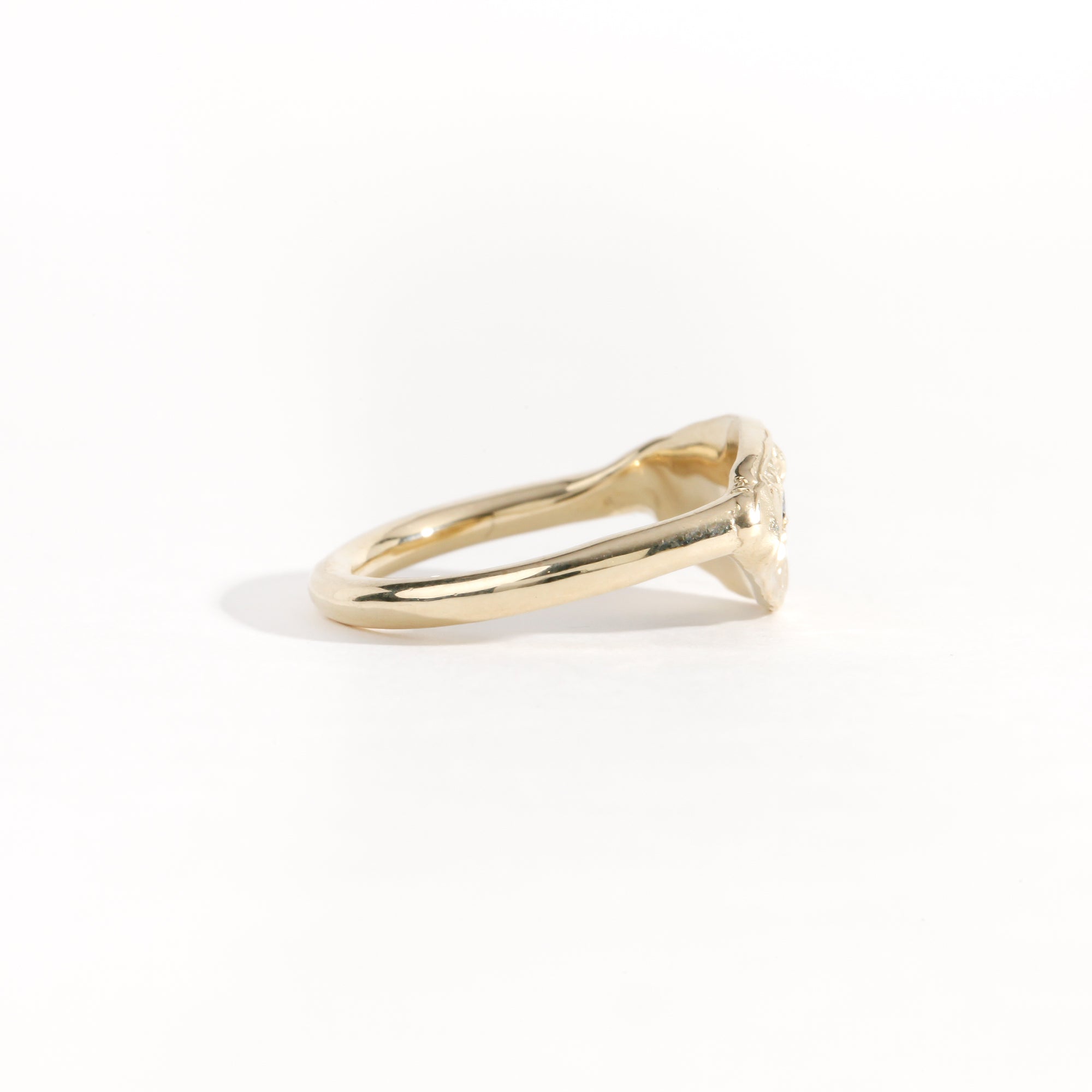 Gold ring featuring wing detailing and blue sapphire. Handmade and bespoke finish.