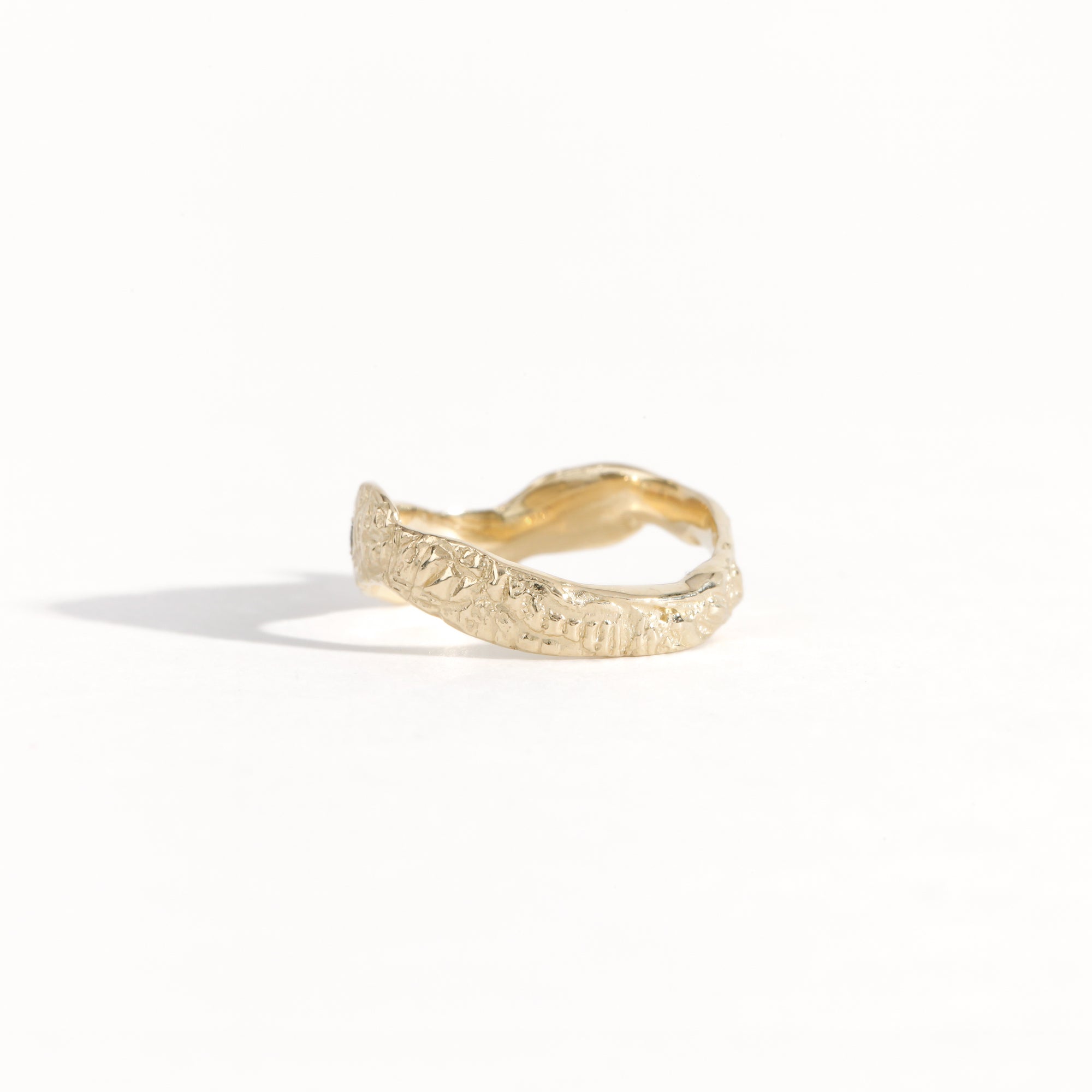 Gold ring featuring wing detailing and blue sapphire. Handmade and bespoke finish.