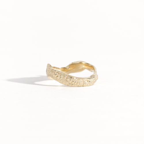 Gold ring featuring wing detailing and blue sapphire. Handmade and bespoke finish.