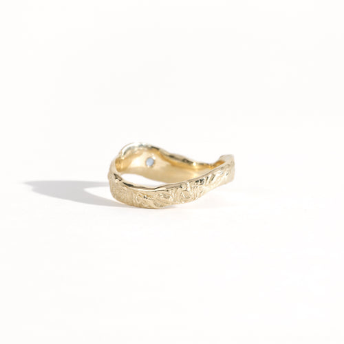 Gold ring featuring wing detailing and blue sapphire. Handmade and bespoke finish.