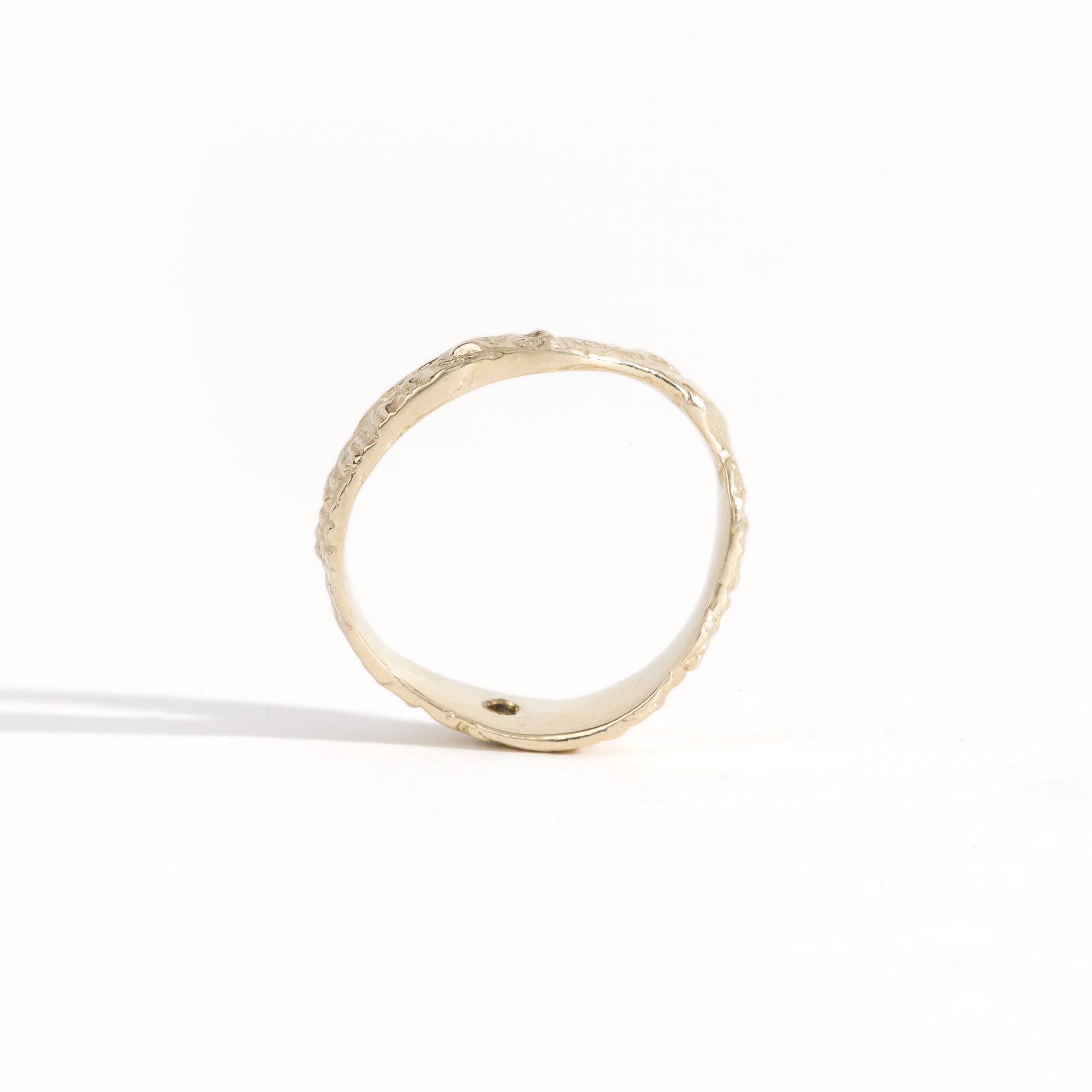 Gold ring featuring wing detailing and blue sapphire. Handmade and bespoke finish.