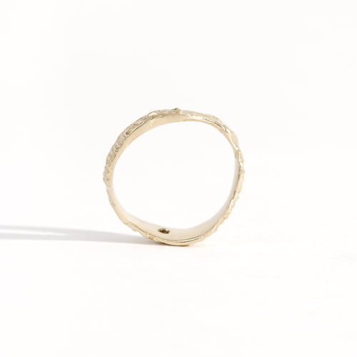 Gold ring featuring wing detailing and blue sapphire. Handmade and bespoke finish.