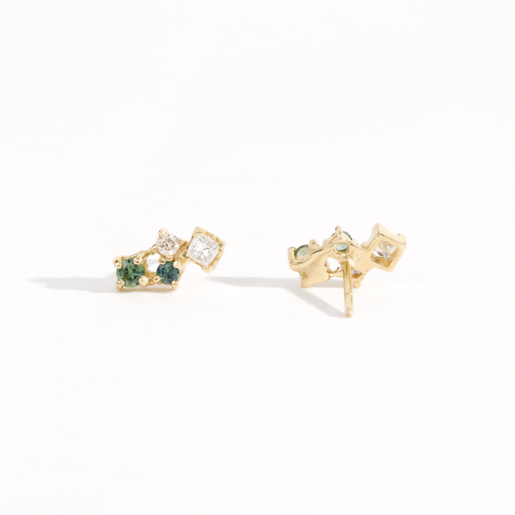 A pair of cluster earring studs with ethically sourced Australian sapphires and diamonds with mixed shapes. Hand crafted in 9ct yellow gold by Black Finch Jewellery