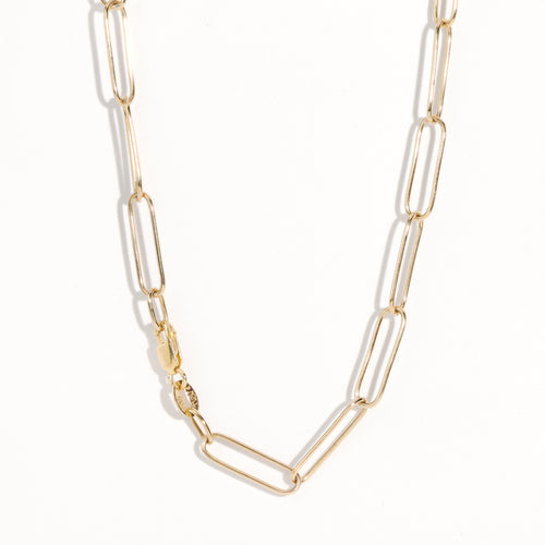 Gold paperclip chain by Black Finch Jewellery. Long thin gold links connected on as a chain.