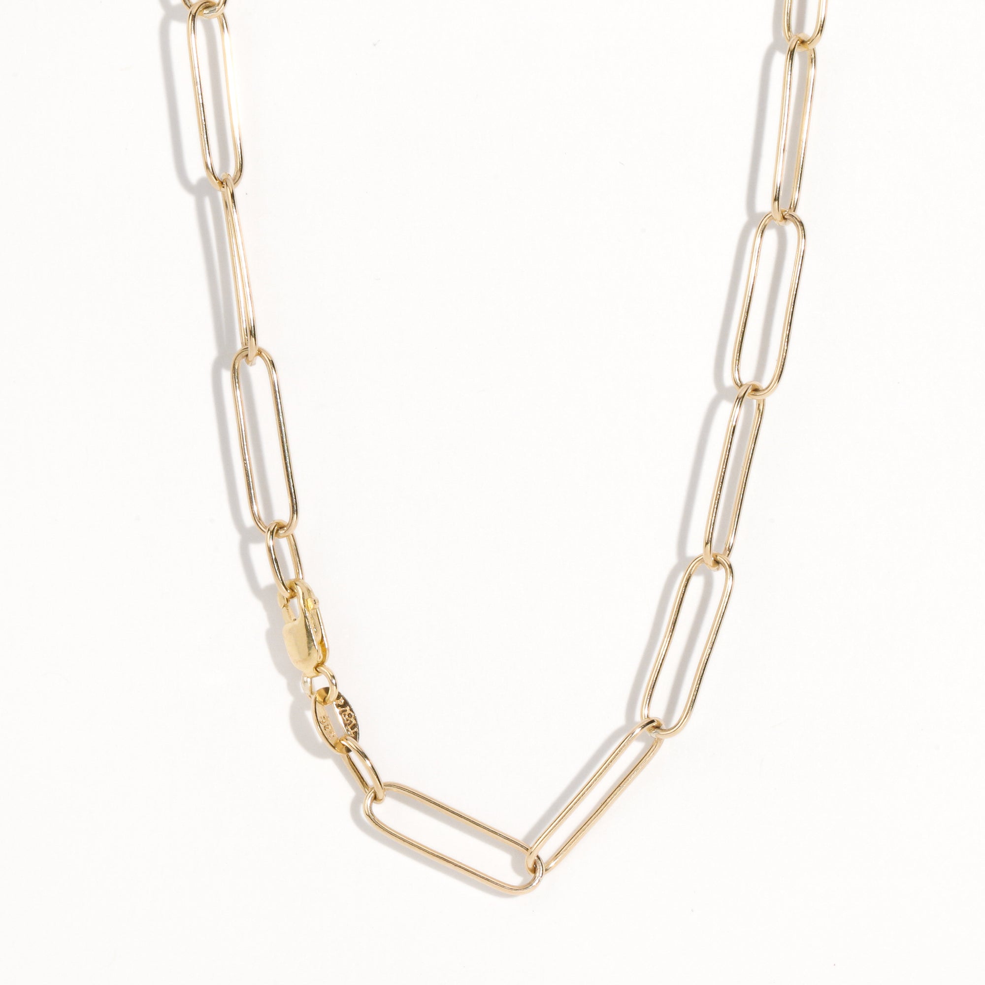 Gold paperclip chain by Black Finch Jewellery. Long thin gold links connected on as a chain.