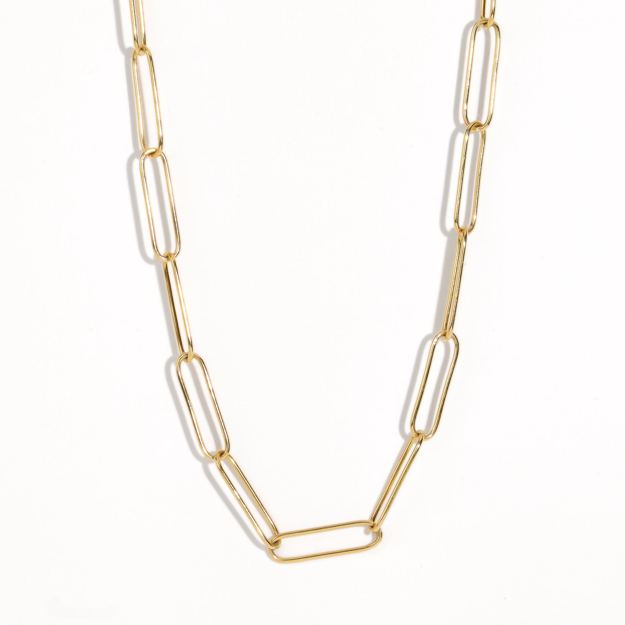 Gold paperclip chain by Black Finch Jewellery. Long thin gold links connected on as a chain.