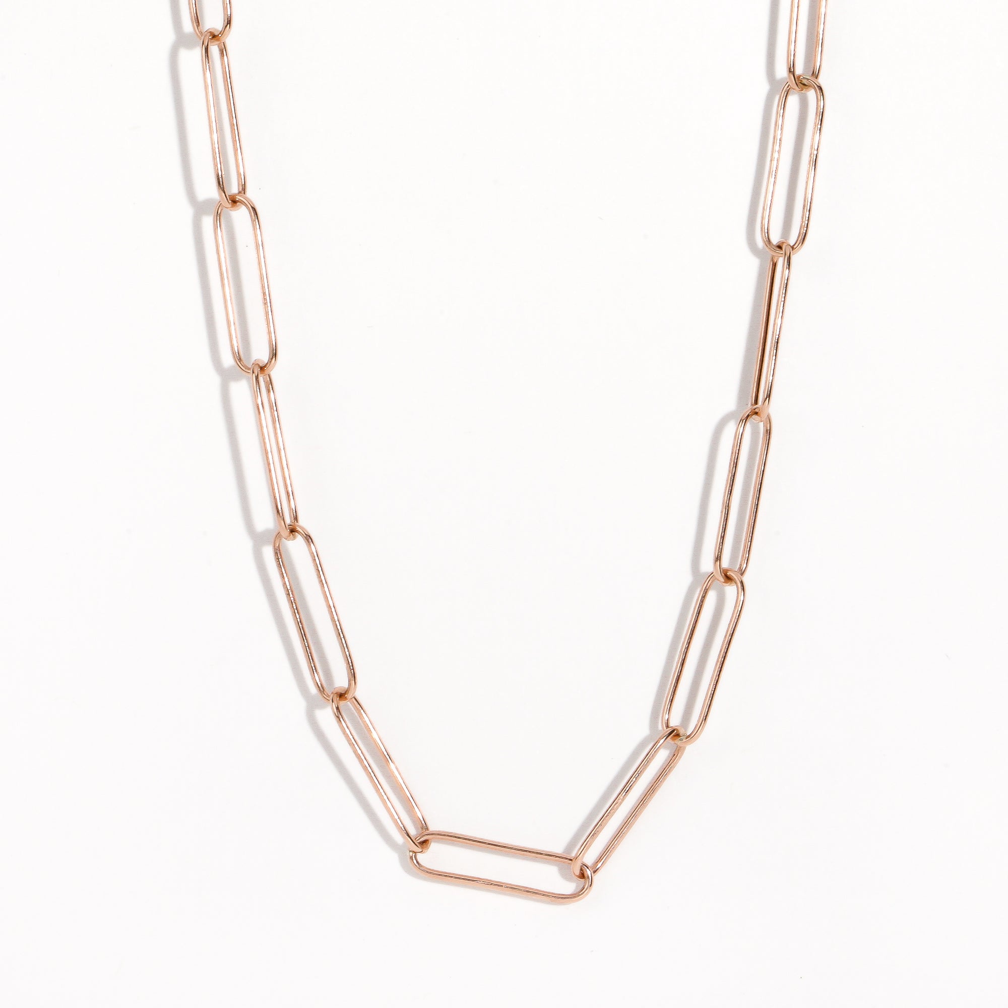 Detailed image shot of clasp of rose gold paperclip chain by Black Finch Jewellery. Long thin rose gold links connected on as a chain.