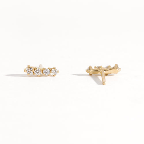 A pair of earring studs crafted with 9ct recycled refined yellow gold with a row of four diamonds by Black Finch Jewellery