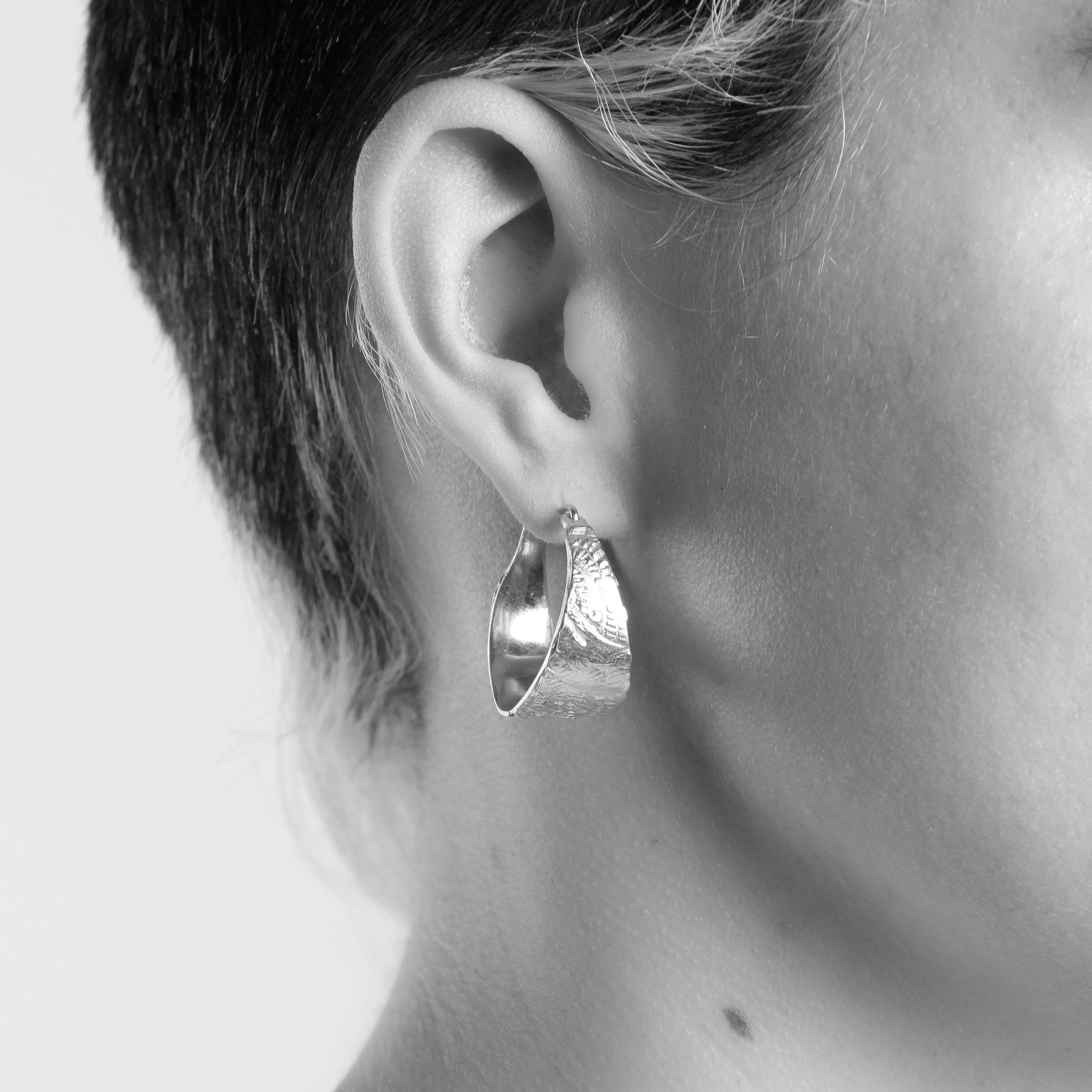 Bespoke, handcrafted 9ct yellow gold textured hoops. Ethically sourced recycled, refined gold. Shown on model.