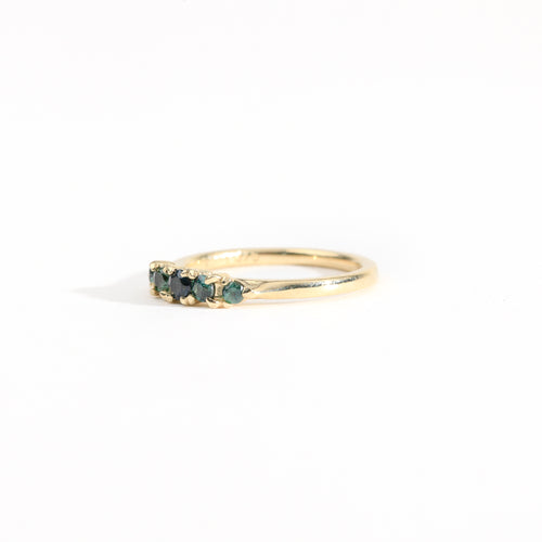 A bespoke handcrafted five stone ring in yellow gold with ethically sourced Australian teal sapphires