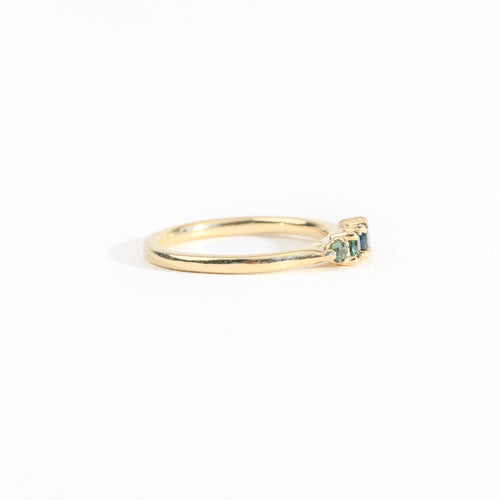 A bespoke handcrafted five stone ring in yellow gold with ethically sourced Australian teal sapphires