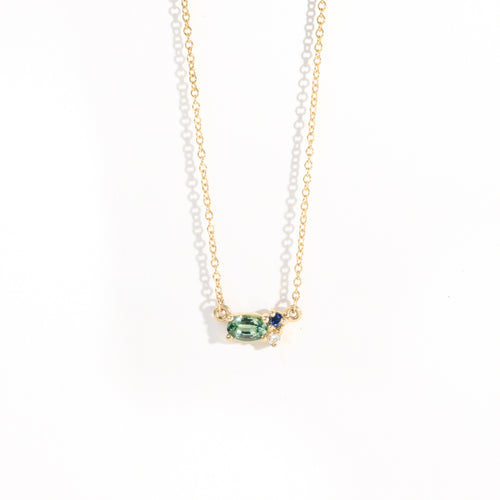 9 carat yellow gold three stone pendant, with a central green ethically sourced Australian sapphire, a deep blue round sapphire and a white diamond. 