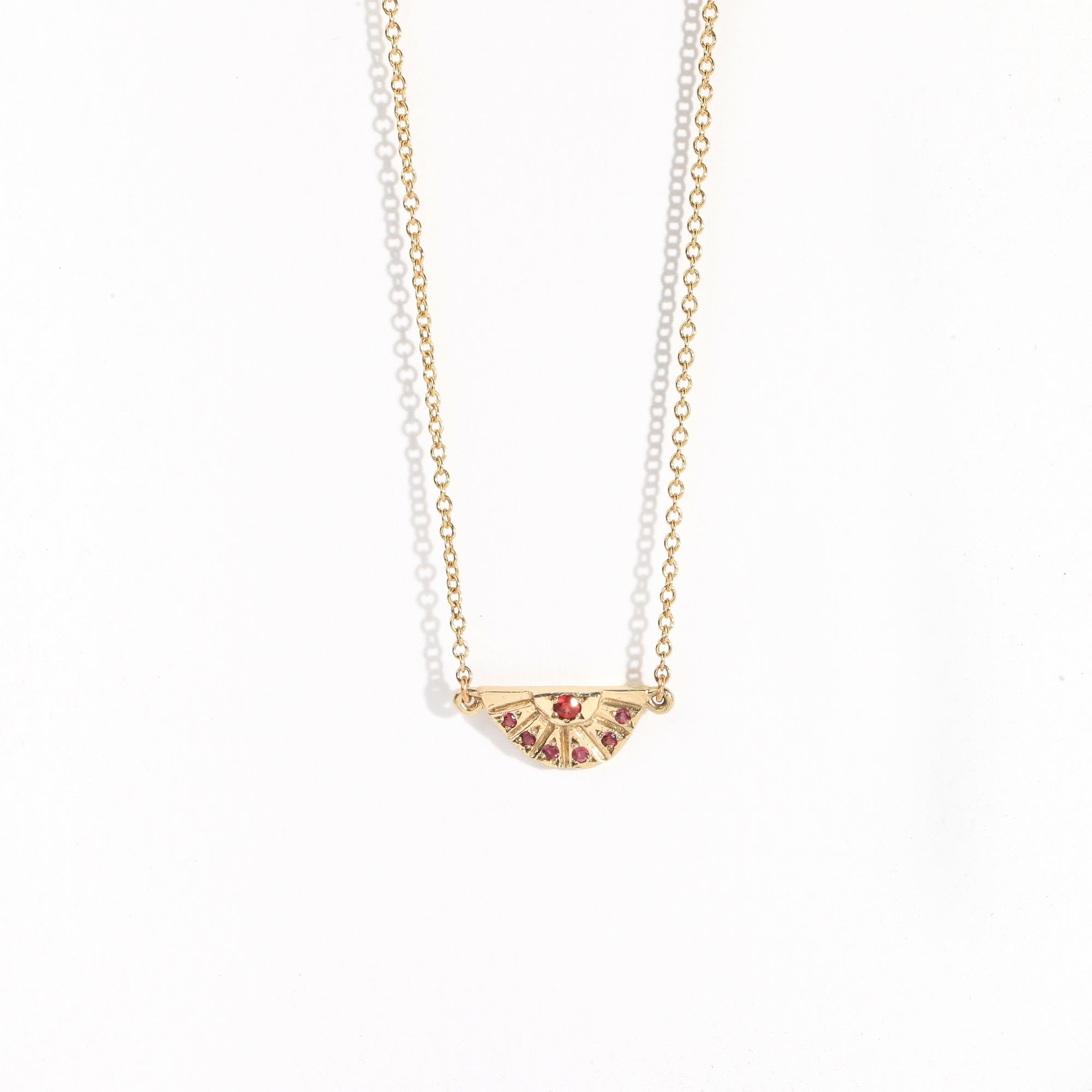 9ct yellow gold pendant rising sun detailed with red and pink sapphires by Black Finch Jewellery
